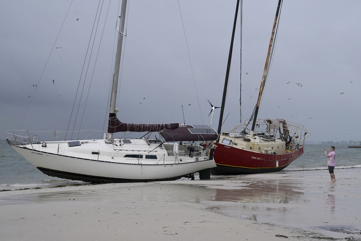Boats sit on the beach in the aftermath of Tropical Storm Eta, Thursday, Nov. 12, 2020, in Gulfport, Fla. Eta dumped torrents of blustery rain on Florida