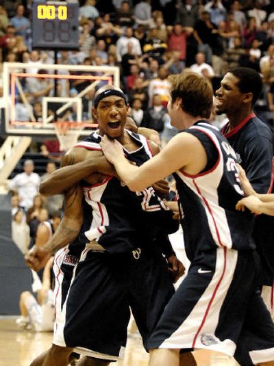 
Bulldogs teammates mob Erroll Knight following the game after his 3-pointer with 8 seconds left gave Gonzaga a 64-63 win at San Diego.
 (Associated Press / The Spokesman-Review)