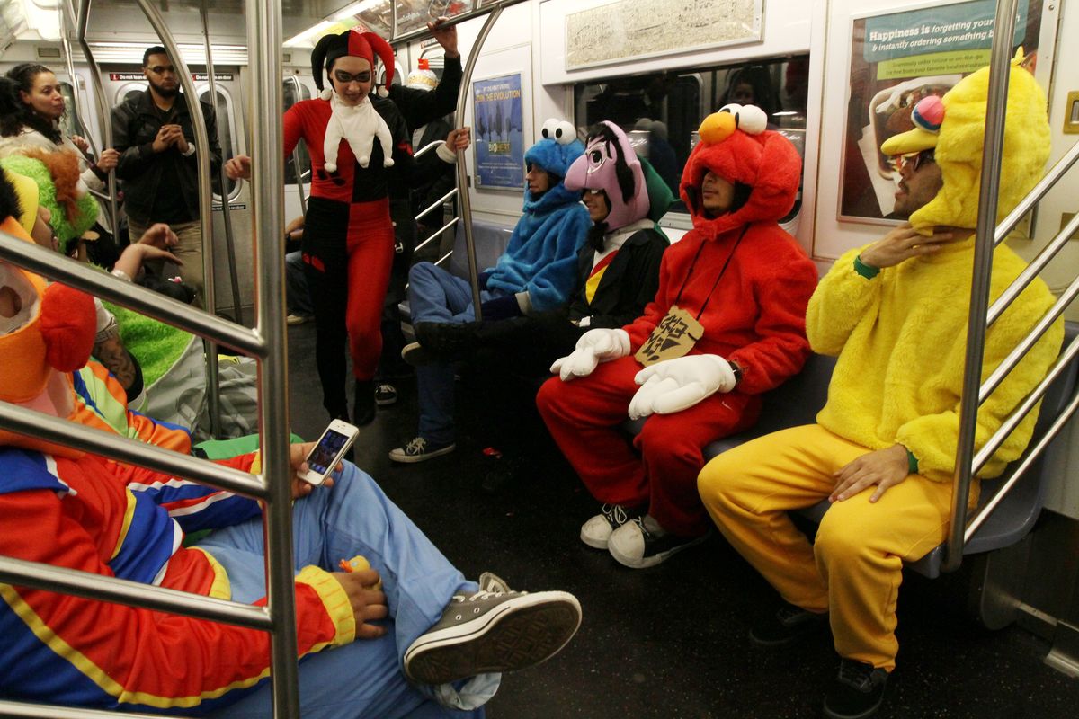 FILE - This Nov. 1, 2011 file photo shows a group of friends dressed as Sesame Street characters  after attending the Village Halloween Parade in New York. From the wrath of nature to the wrath of young children: From Maryland to Kentucky to Maine, Halloween festivities were being canceled or postponed. The most high-profile postponement was that of New York