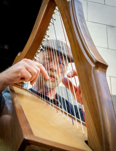 Mark Majeski plays his Celtic lap harp on Main Street in downtown Spokane on Tuesday. In its 22nd year, Street Music Week is a fundraiser for Second Harvest’s food bank. Musicians play noon to 1 p.m. through Friday in downtown Spokane, Coeur d’Alene and the Garland District.  (COLIN MULVANY/THE SPOKESMAN-REVIEW)