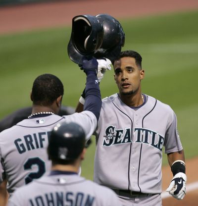 Seattle’s Franklin Gutierrez, right, taps helmets with Ken Griffey Jr. after Gutierrez hit a two-run homer.  (Associated Press / The Spokesman-Review)
