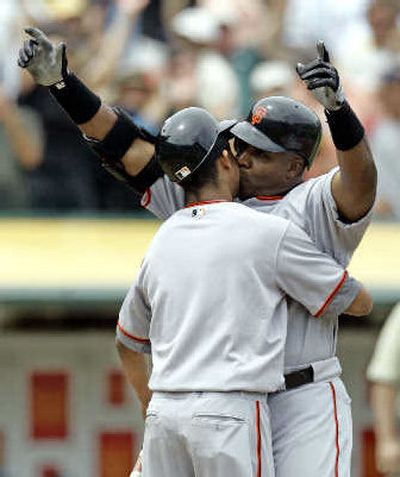 
Barry Bonds kisses his son Nikolai at home plate after hitting his 714th career home run Saturday.
 (Associated Press / The Spokesman-Review)
