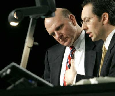 
Steve Ballmer, left, Microsoft CEO, listens to Chris Capossela, Microsoft vice president of business, as he previews a product at the company's 