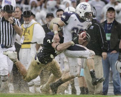 Sioux Falls running back Erik Cimpl is forced out of bounds by Carroll linebacker Brandon Day. (Associated Press / The Spokesman-Review)