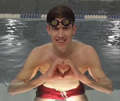 Fordham University sophomore Danny Thrall forms the shape of a heart over the scars from his recent open-heart surgery.  (Associated Press / The Spokesman-Review)