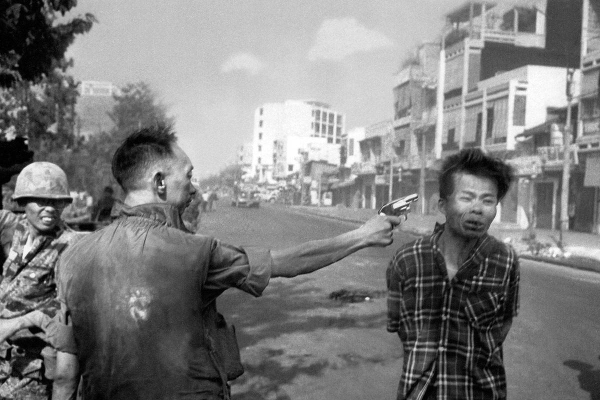 In this Feb. 1, 1968, file photo, South Vietnamese Gen. Nguyen Ngoc Loan, chief of the National Police, fires his pistol into the head of suspected Viet Cong officer Nguyen Van Lem (also known as Bay Lop) on a Saigon street, early in the Tet Offensive. “Vietnam: The Real War,” a collection of 58 photographs taken by the Associated Press opens to the public today in Hanoi, Vietnam. (Associated Press)