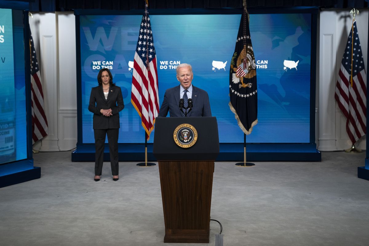Vice President Kamala Harris listens as President Joe Biden speaks about the COVID-19 vaccination program Wednesday in the South Court Auditorium on the White House campus. (Evan Vucci)