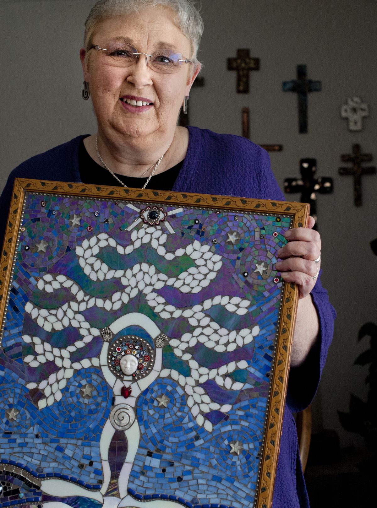 Connie Stout holds a glass mosaic she and her sister created that got the pair hooked on the mosaic art form two years ago. Stout has been a critical care nurse at Sacred Heart for 35 years. (Tyler Tjomsland)