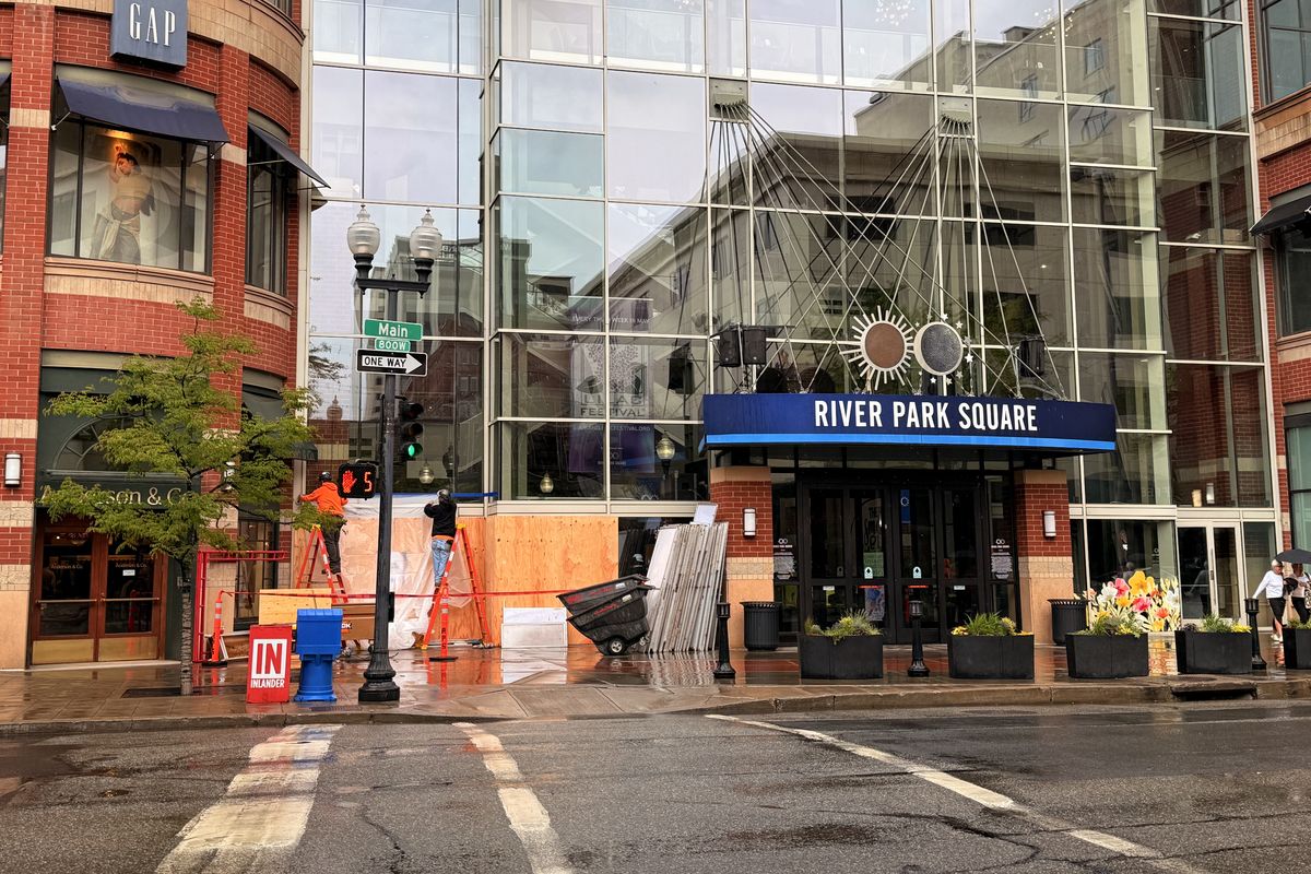 Crews repair the front of Riverpark Square after a Ford Mustang crashed through the building on Thursday night.  (Alexandra Duggan / The Spokesman-Review)