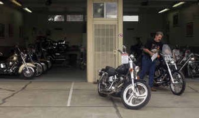 
Don Bailey, owner of House of Custom Cycles, 8007 E. Trent Ave., wheels out a Harley-Davidson for display at his new business.
 (Liz Kishimoto / The Spokesman-Review)