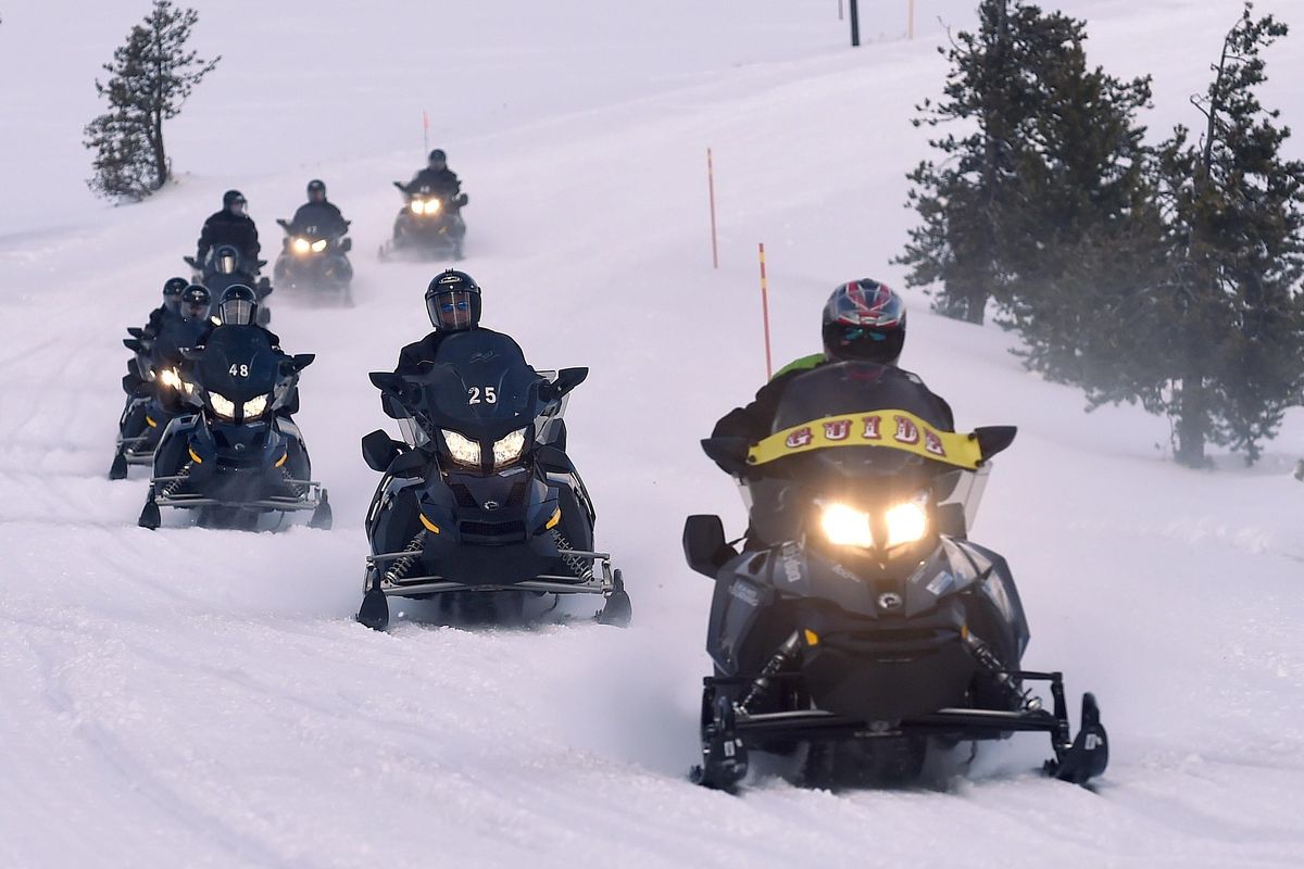 Snowmobilers cruise through Yellowstone National Parkon Jan. 15, 2016, in Montana. (Hannah Potes / AP)