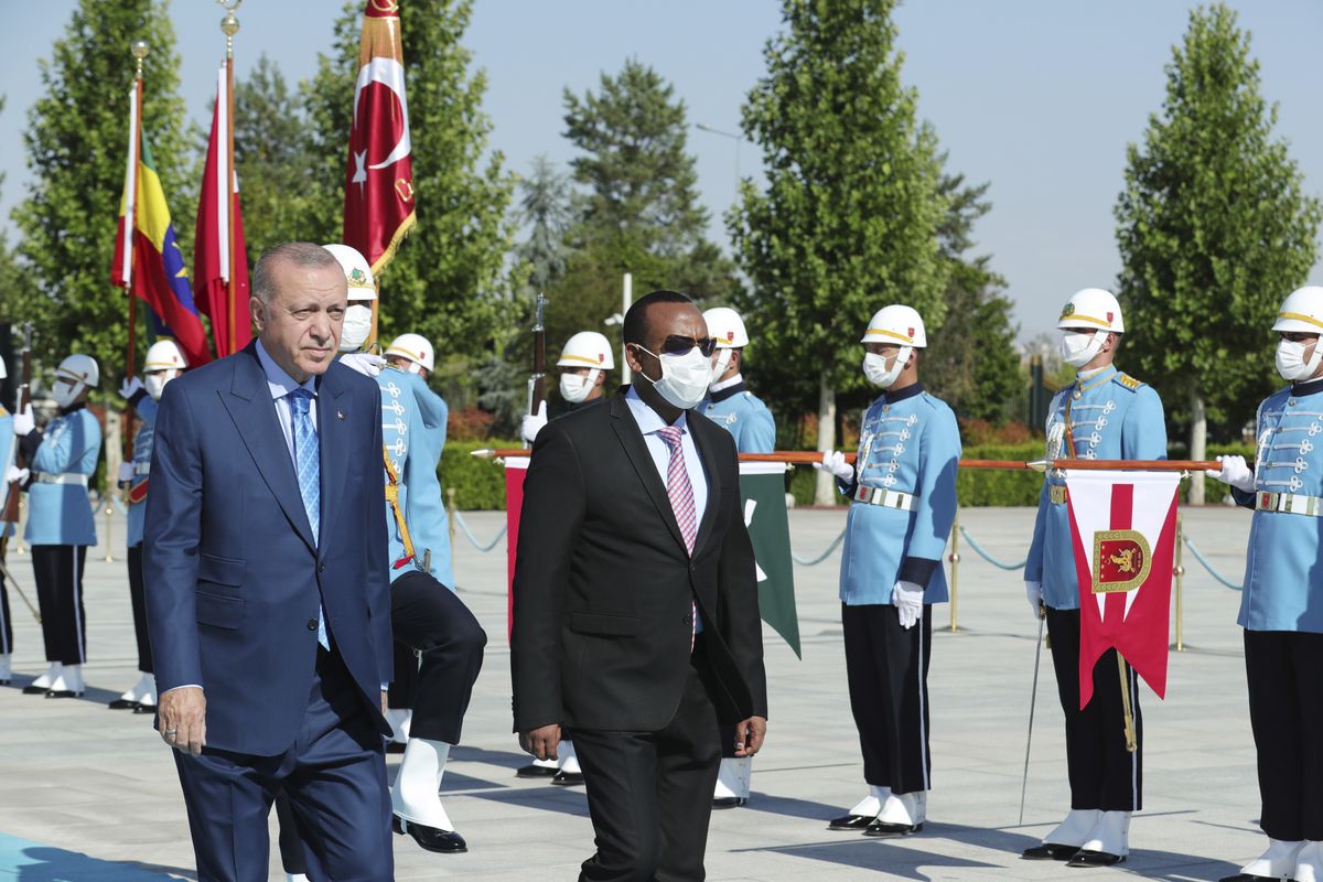 Turkish President Recep Tayyip Erdogan, left, and Ethiopian Prime Minister Abiy Ahmed review a military guard of honour in Ankara, Turkey, Wednesday, Aug. 18, 2021. Erdogan urged Wednesday a peaceful resolution of the Tigray conflict in Ethiopia and also said his country was willing to mediate between Addis Ababa and Sudan for a resolution of a border dispute.  (Mustafa Kamaci)