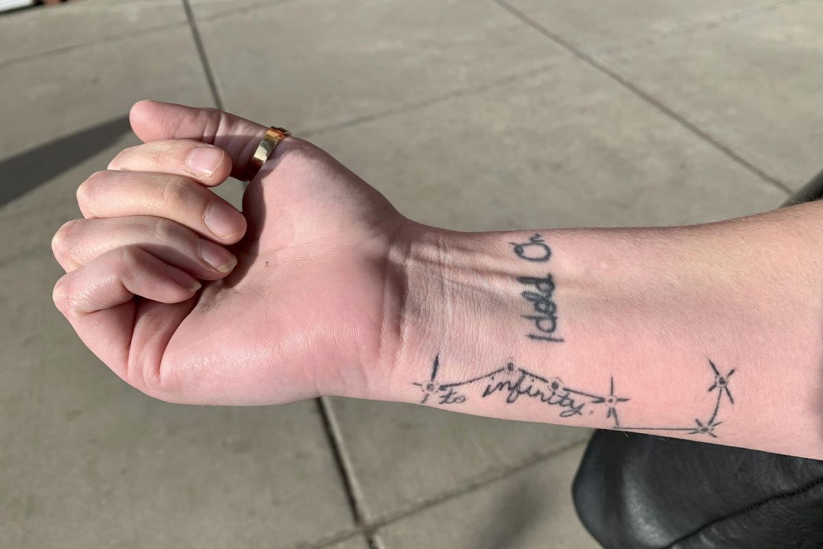 Sexual assault survivor Sam Gaspardo displays her “HOLD ON” and “to infinity” tattoos on her right arm Dec. 18, 2018, in Minneapolis. The “HOLD ON” tattoo is in her mother’s handwriting. It’s to remind Sam to hold on when she’s struggling. (Jeff Baenen / AP)