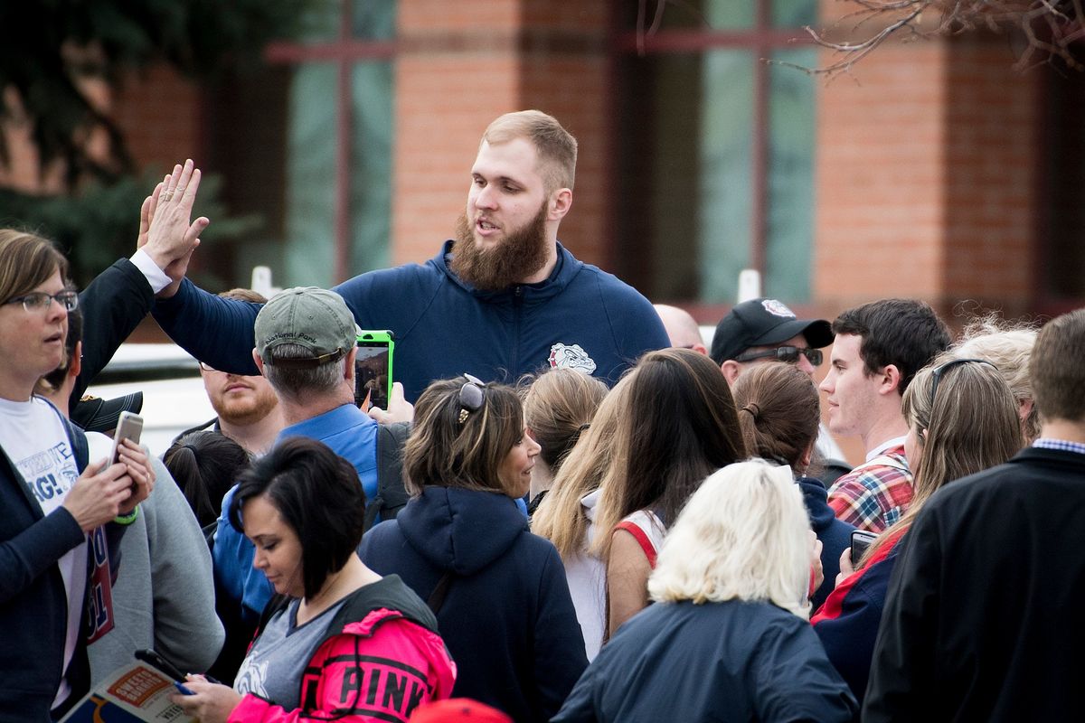 Gonzaga center Przemek Karnowski signs autographs at a homecoming rally after the Zags came up short against North Carolina in the 2017 national championship game.  (Colin Mulvany/The Spokesman-Review)