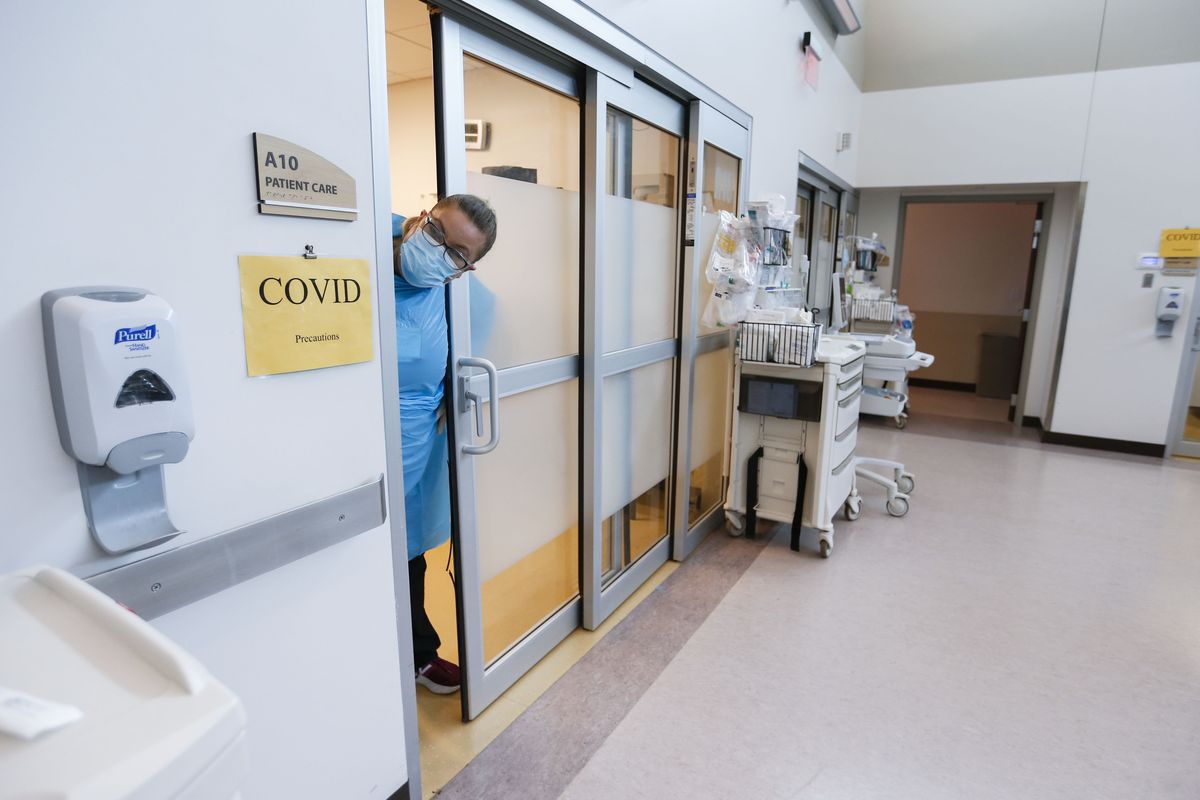 A nurse sticks her head out of the room of a COVID-19 patient in the CoxHealth Emergency Department on July 16 in Springfield, Mo.  (Nathan Papes)