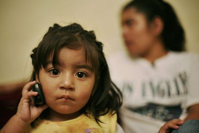 Esther Sulamita plays with her mother’s phone at their house in Guatemala City.  (Associated Press / The Spokesman-Review)