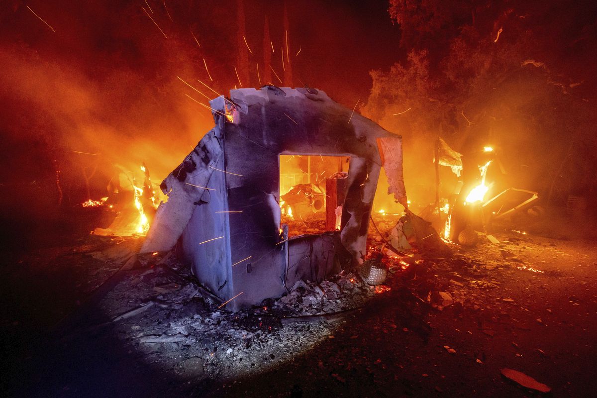 Flames from the LNU Lightning Complex fires consume a home in unincorporated Napa County, Calif., on Wednesday, Aug. 19, 2020. Fire crews across the region scrambled to contain dozens of wildfires sparked by lightning strikes. (Noah Berger)