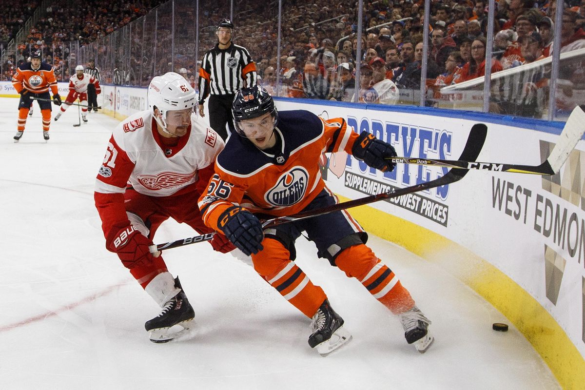 Detroit’s Xavier Ouellet, left,  and Edmonton’s Kailer Yamamoto  vie for the puck during the second period of an NHL game in Edmonton, Alberta, on Nov. 5, 2017. (Jason Franson / AP)