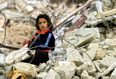 
A Palestinian girl sifts through the rubble of a destroyed home, on the edge of the Rafah refugee camp near the border with Egypt, southern Gaza Strip, Saturday.A Palestinian girl sifts through the rubble of a destroyed home, on the edge of the Rafah refugee camp near the border with Egypt, southern Gaza Strip, Saturday.
 (Associated PressAssociated Press / The Spokesman-Review)