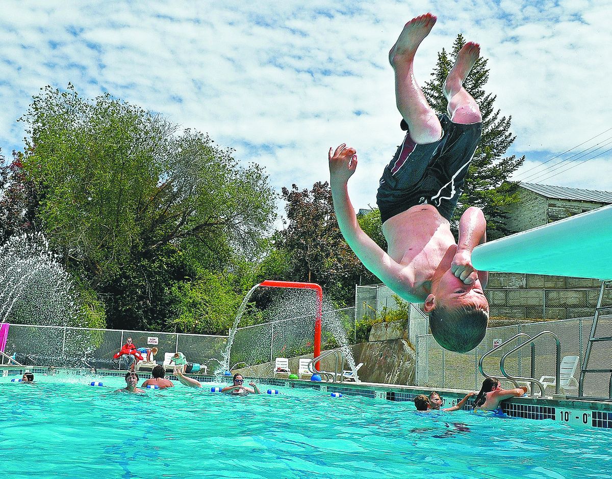 Trevon Wilson takes a flip off the spring board at the new city pool in Davenport, Wash., where taxpayers also paid for a new skate park.  (Christopher Anderson)