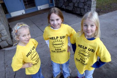 
Catherine James, 5, Julia Jaworski, 7, and Elisa James, 7, wear T-shirts with a message about keeping Sorensen Elementary open Wednesday  in front of their school. The shirts are part of the campaign used by the Parent Teacher Association at the school. 
 (Photos by JESSE TINSLEY / The Spokesman-Review)