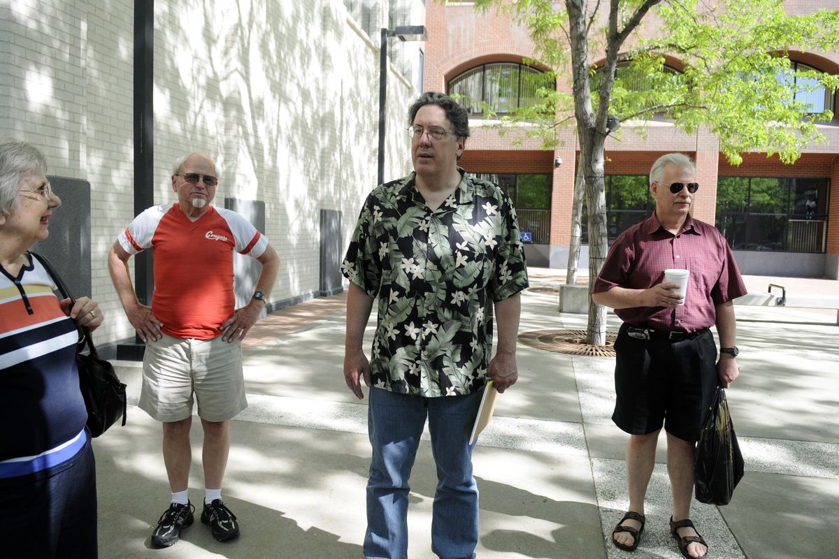 Paul Turner greets competitors in the courtyard of the Spokesman-Review building during the The Slice