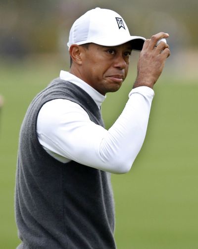 Tiger Woods, who shot 82 and missed the cut, acknowledges the gallery during the second round of the Phoenix Open. (Associated Press)