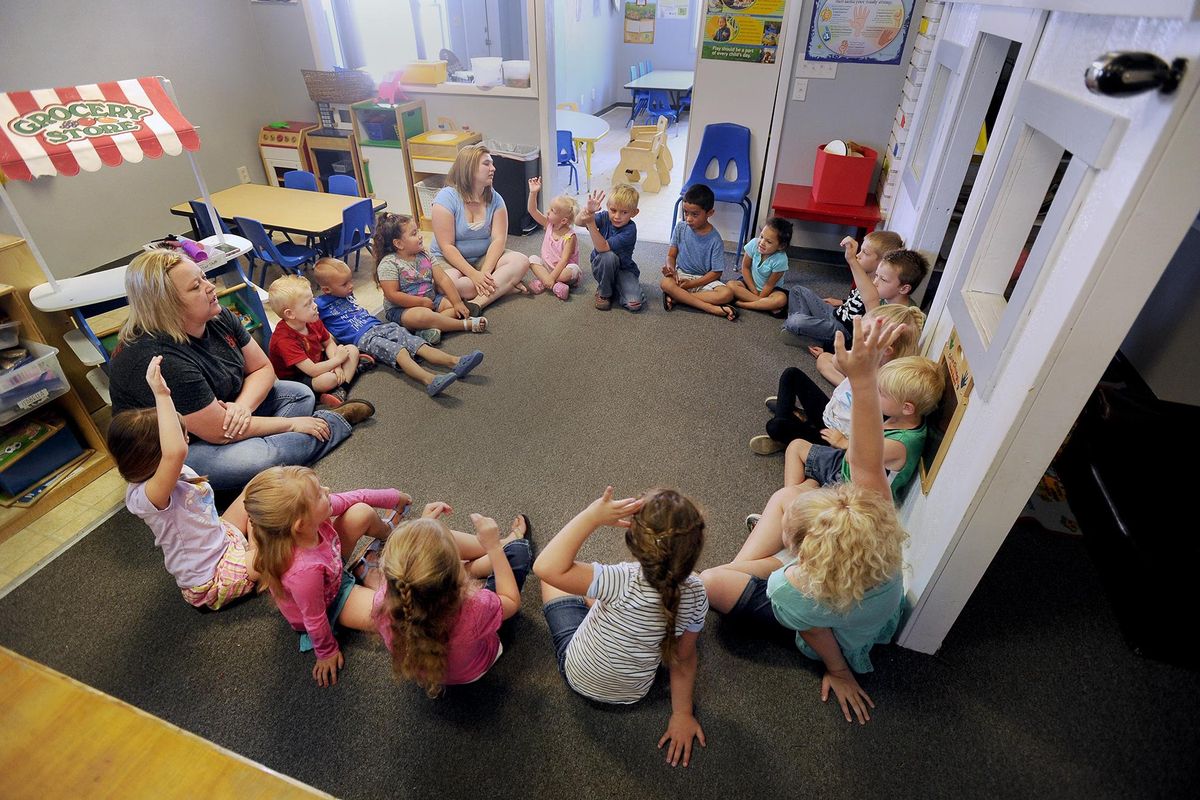Students at Kids Korner preschool start the day with circle time. The students are given a chance to talk about their activities the day before, and instructors also outline what students will be doing the rest of the day. (Monte LaOrange / AP)