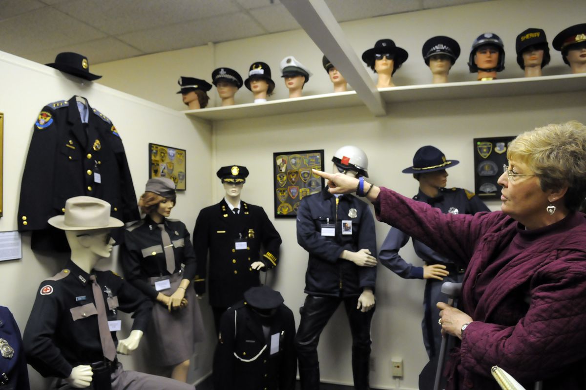 Sue Walker, right, points out the highlights of the uniform display inside the Spokane Law Enforcement Museum at 1201 W. First Ave. in Spokane. The museum opens to the public April 27, 2010. (Jesse Tinsley / The Spokesman-Review)
