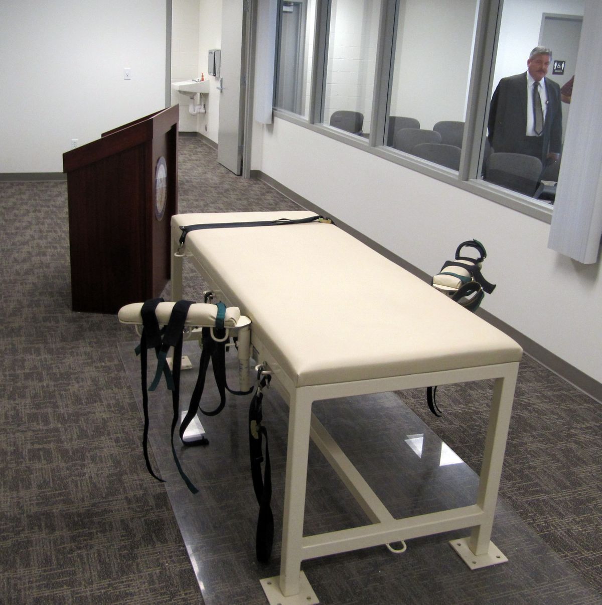 The execution chamber at the Idaho Maximum Security Institution in Boise is shown in late October, with Security Institution Warden Randy Blades looking in. Paul Ezra Rhoades, who was convicted of killing three people in Idaho Falls and Blackfoot in 1987, is scheduled to be executed by lethal injection Friday. (Associated Press)