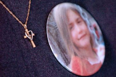 
Cheryl Horne wears a gold cross she received from the Groene family after she made buttons for them. 
 (The Spokesman-Review)