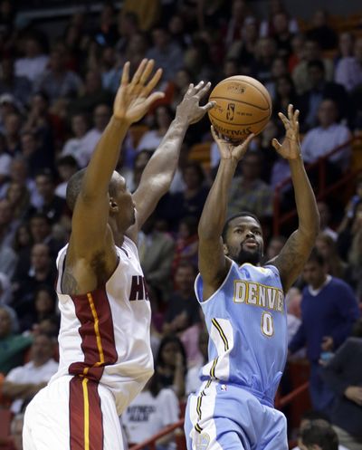 Nuggets’ Aaron Brooks shoots as Heat’s Chris Bosh defends. Denver claimed its fifth win in 18 games. (Associated Press)