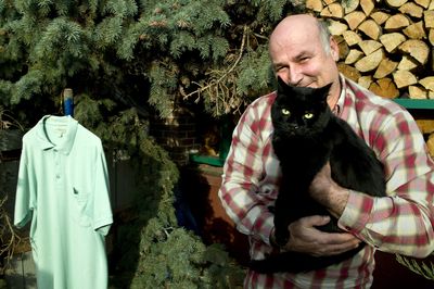 With coyotes roaming his Audubon Park neighborhood, Steve James is concerned about his cat, Papa Midnight, who lives outside. He hung a shirt in front of the cat’s house to ward off coyotes. (Colin Mulvany / The Spokesman-Review)