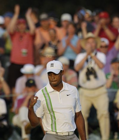 Tiger Woods finishes the day with a birdie on the 18th. (Associated Press)