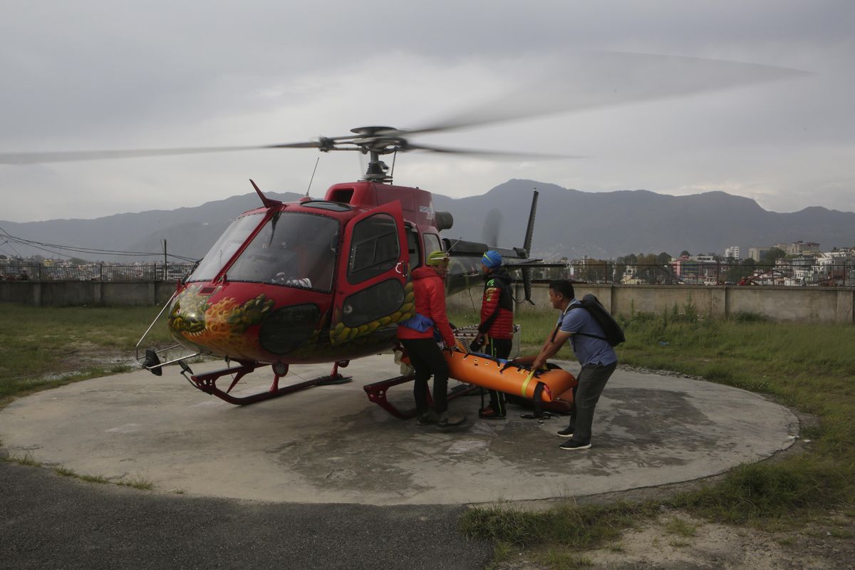 A helicopter carrying the body of famed Swiss climber Ueli Steck arrives at Teaching Hospital in Kathmandu, Nepal, April 30, 2017.  Steck, 40, one of the most-renowned mountaineers of his generation, was killed Sunday in a mountaineering accident near Mount Everest in Nepal, expedition organizers said. He was best known for his speed-climbing, including setting several records for ascending the north face of the Eiger, a classic mountaineering peak in the Bernese Alps that he climbed in two hours and 47 minutes without using a rope. (NIranjan Shrestha / Associated Press)