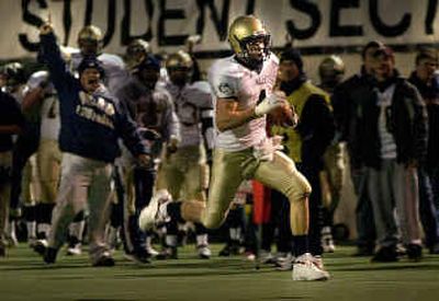 
Mead wide receiver Andy Mattingly (4) is cheered on by players and coaches as he heads for the end zone on a 41-yard touchdown run off a reverse in the first half of action Friday at Albi Stadium. 
 (Brian Plonka / The Spokesman-Review)