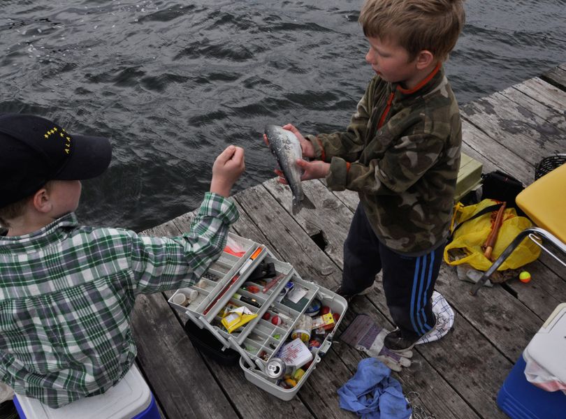 Urban Albright, 6, of Blaine, Wash., shows off the trout he caught at Williams Lake off the dock at Bunker's Resort. He was fishing on April 28, 2013, the opening day of Washington's lowland trout fishing season.  (Rich Landers)