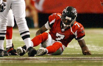 
Michael Vick sprained a right knee ligament Sunday. 
 (Associated Press / The Spokesman-Review)