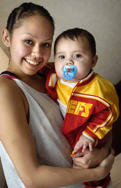 
Taunie Cullooyah holds her 7-month-old son, Lewis. The senior divides her time among basketball, school and her son, with help from her family and her close-knit community.
 (Holly Pickett / The Spokesman-Review)