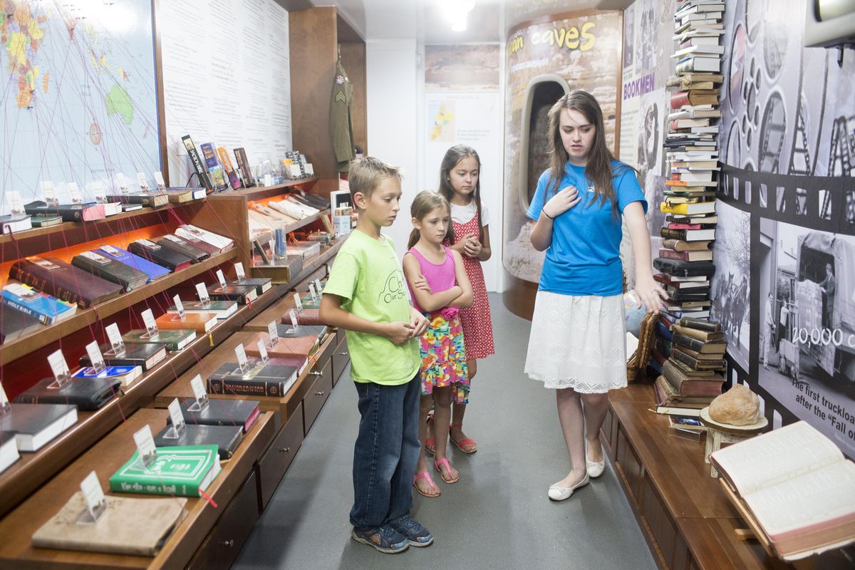 Oksana Krutikov, right, gives a group of children a tour through the traveling exhibit that explains the history of the Bible Friday, Aug. 25, 2017 at the Light of the Gospel Church in Spokane Valley. (Jesse Tinsley / The Spokesman-Review)