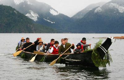 
Members of the Mowachaht-Muchalaht First Nation paddle a traditional canoe decorated with cedar boughs during a memorial ceremony for Luna in Gold River, B.C., on Monday. 
 (Associated Press / The Spokesman-Review)