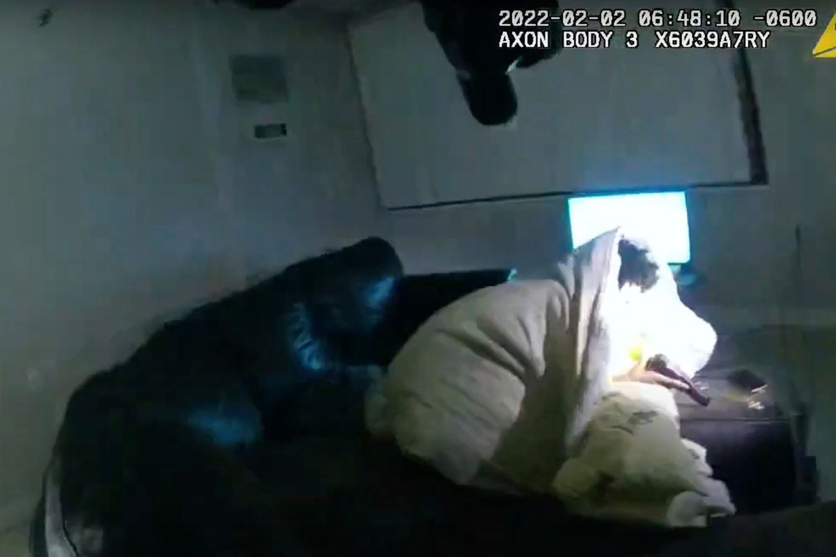 In this image taken from Minneapolis Police Department body camera video and released by the city of Minneapolis, 22-year-old Amir Locke wrapped in a blanket on a couch holding a gun moments before he was fatally shot by Minneapolis police as they were executing a search warrant in a homicide investigation on Wednesday, Feb. 2, 2022, in Minneapolis. Authorities have not said if Locke was connected to the homicide investigation or named in the warrant.  (HOGP)