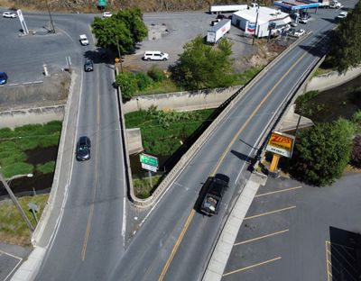 The side-by-side bridges that bring together U.S. 195 and Highway 26 on the north end of Colfax over the Palouse River channel were scheduled for replacement soon, but with state budget shortfalls, the bridge renovation is now scheduled for 2029. (Jesse Tinsley/The Spokesman-Review)