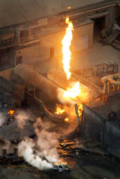 
Flames shoot into the sky as a car smolders at Tacoma's Atlas Foundry after an explosion at the business sent a fireball into the sky on Saturday. Associated Press
 (Associated Press / The Spokesman-Review)