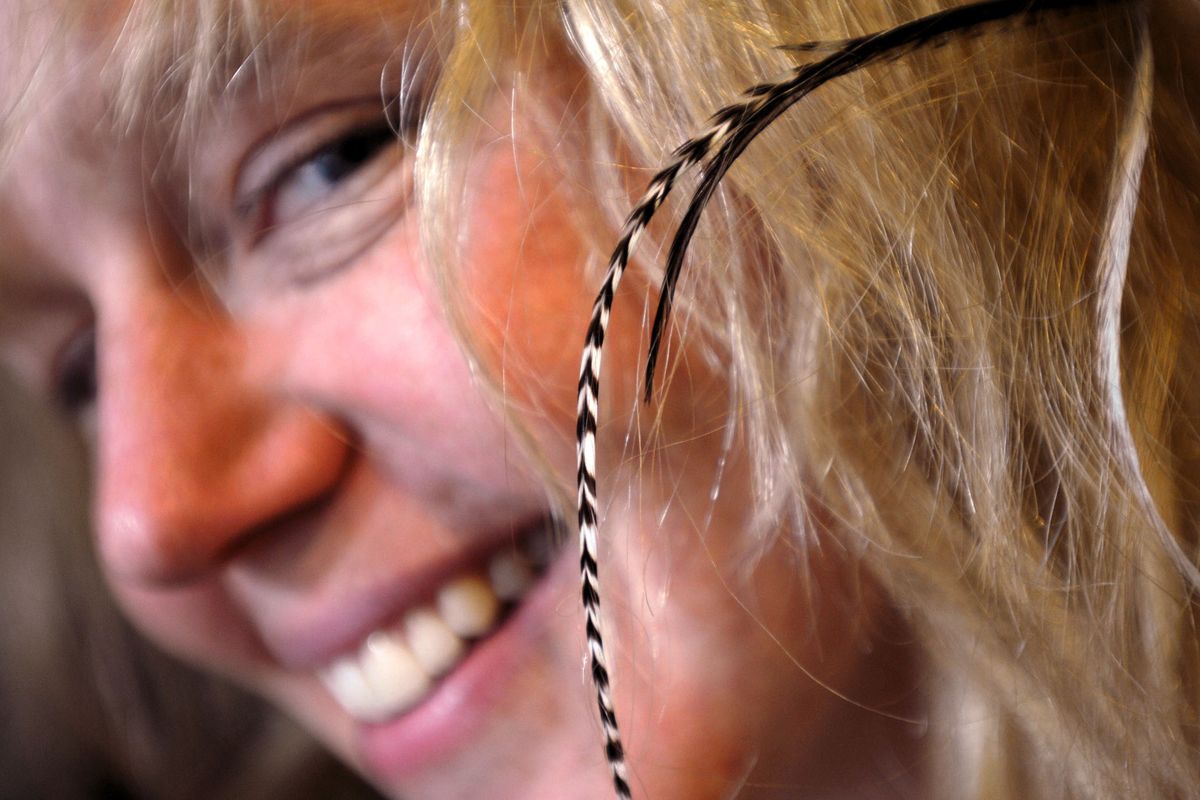 Feathers, like these woven into the hair of Lael Gabrian at Betty’s Divine boutique in Missoula, have become increasingly popular as a fashion statement. (MICHAEL GALLACHER)