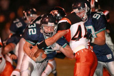 
Lake City running B.J Palmer fights for yardage against Kennewick on Friday night.
 (Cory Murdock / The Spokesman-Review)