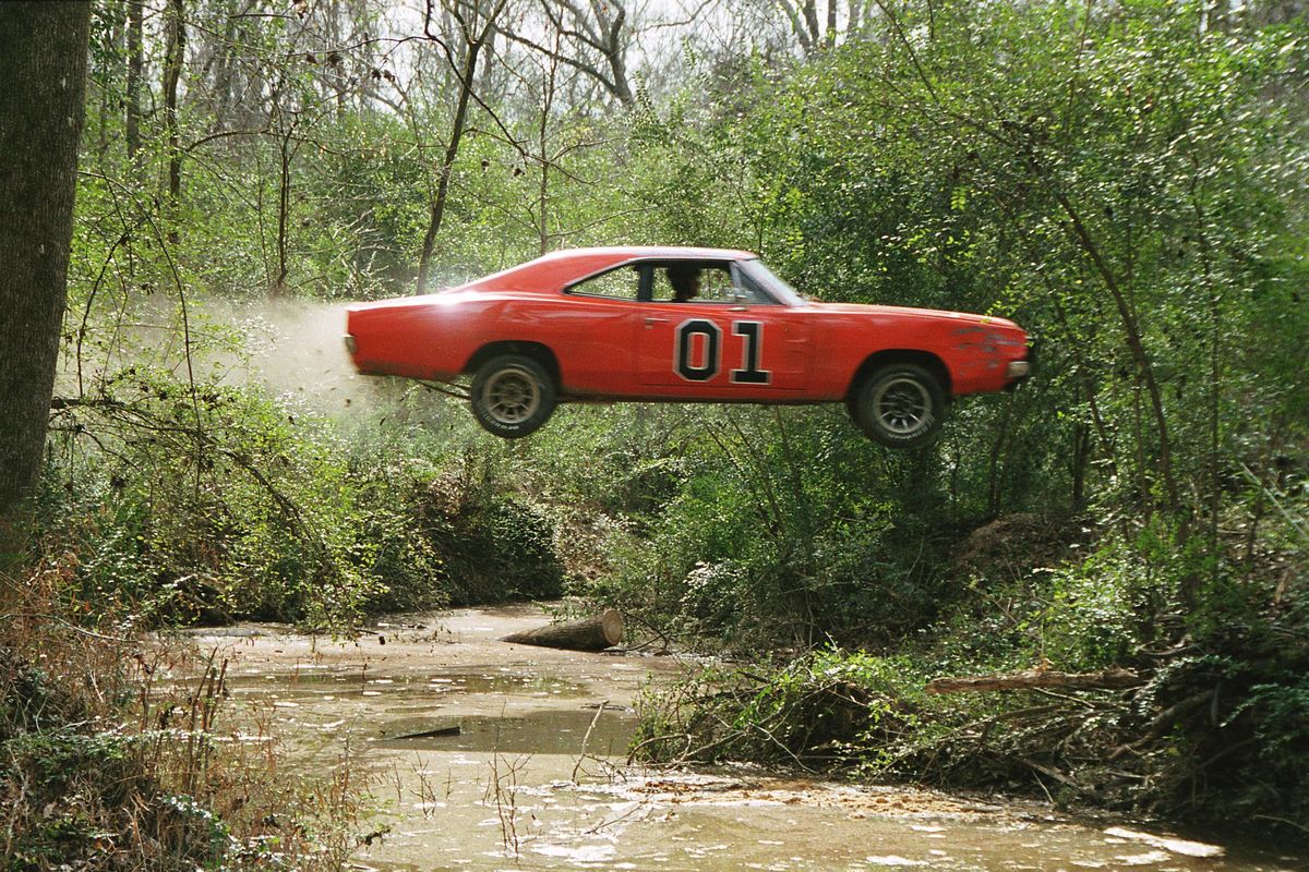 The General Lee sails over a stream in “The Dukes of Hazzard.” (Warner Bros.)