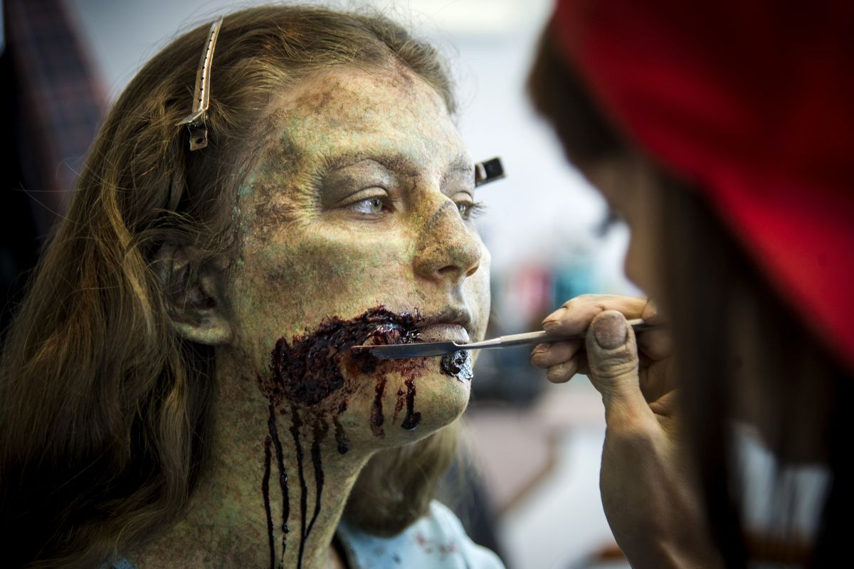 Make-up artist Liz McCracken with the Synapse FX effects crew, puts the finishing touches on extra Logan Binstock as she is transformed into a “Z Nation” zombie. (Colin Mulvany)
