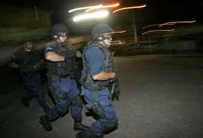 
Mexican federal police on Wednesday patrol the area in San Juan Ixtayopan, a neighborhood of 35,000 people on Mexico City's southern outskirts. 
 (Associated Press / The Spokesman-Review)