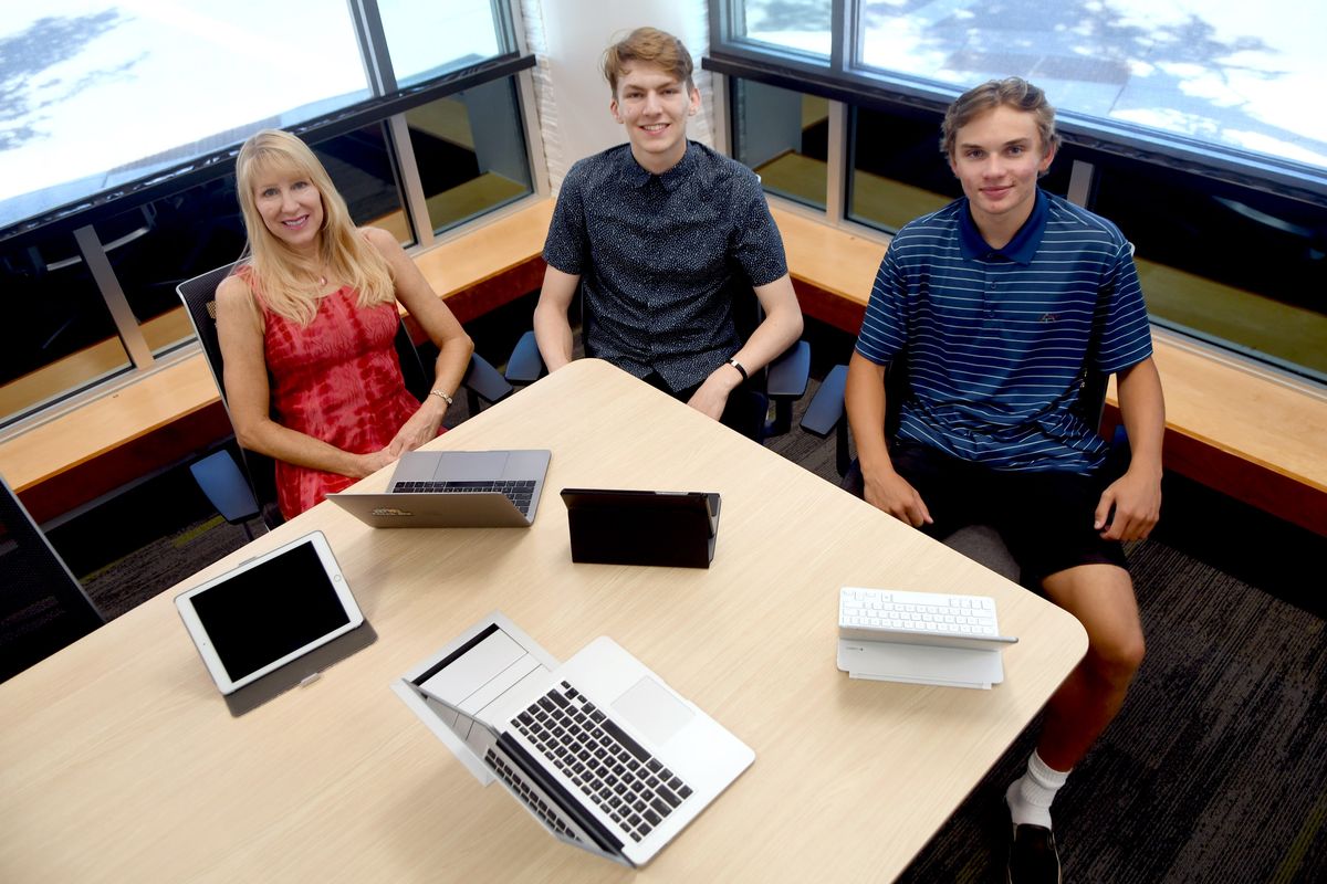 Coeur d’Alene High 2020 graduate Morgan Dixon, center, along with his mother, Karen Johnson, and friend Justin Jaworski have started a nonprofit called Imagination Initiative that will supply affordable tech devices by September to North Idaho and Spokane low-income students. They are photographed at Architects West in Coeur d’Alene on July 14.  (Kathy Plonka/The Spokesman-Review)